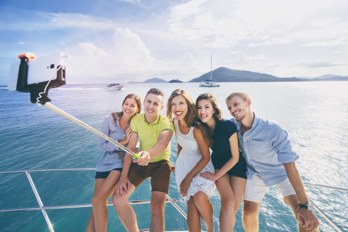 group of friends take selfie on charter yacht